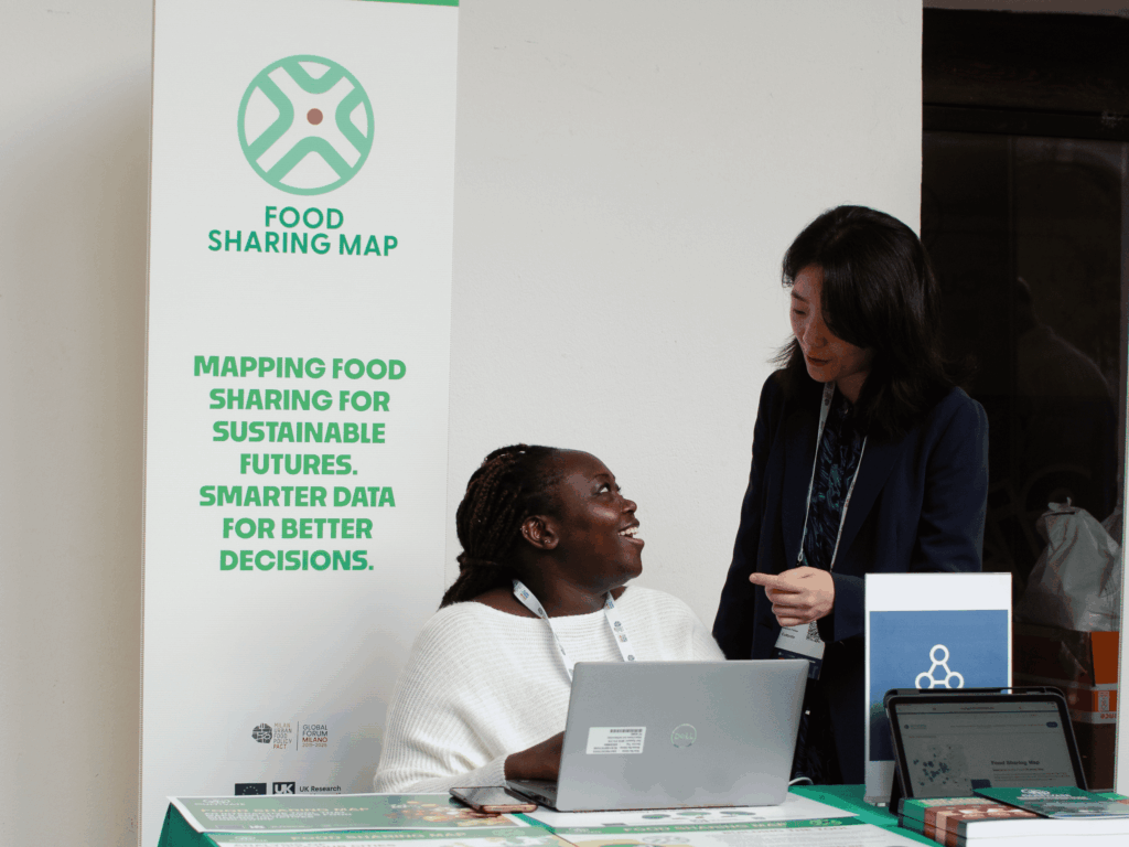 Two people at the Food Sharing Map booth during Marketplaces event
